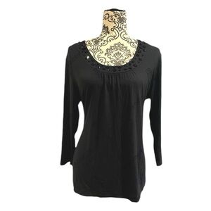 Black top with bejeweled neckline.